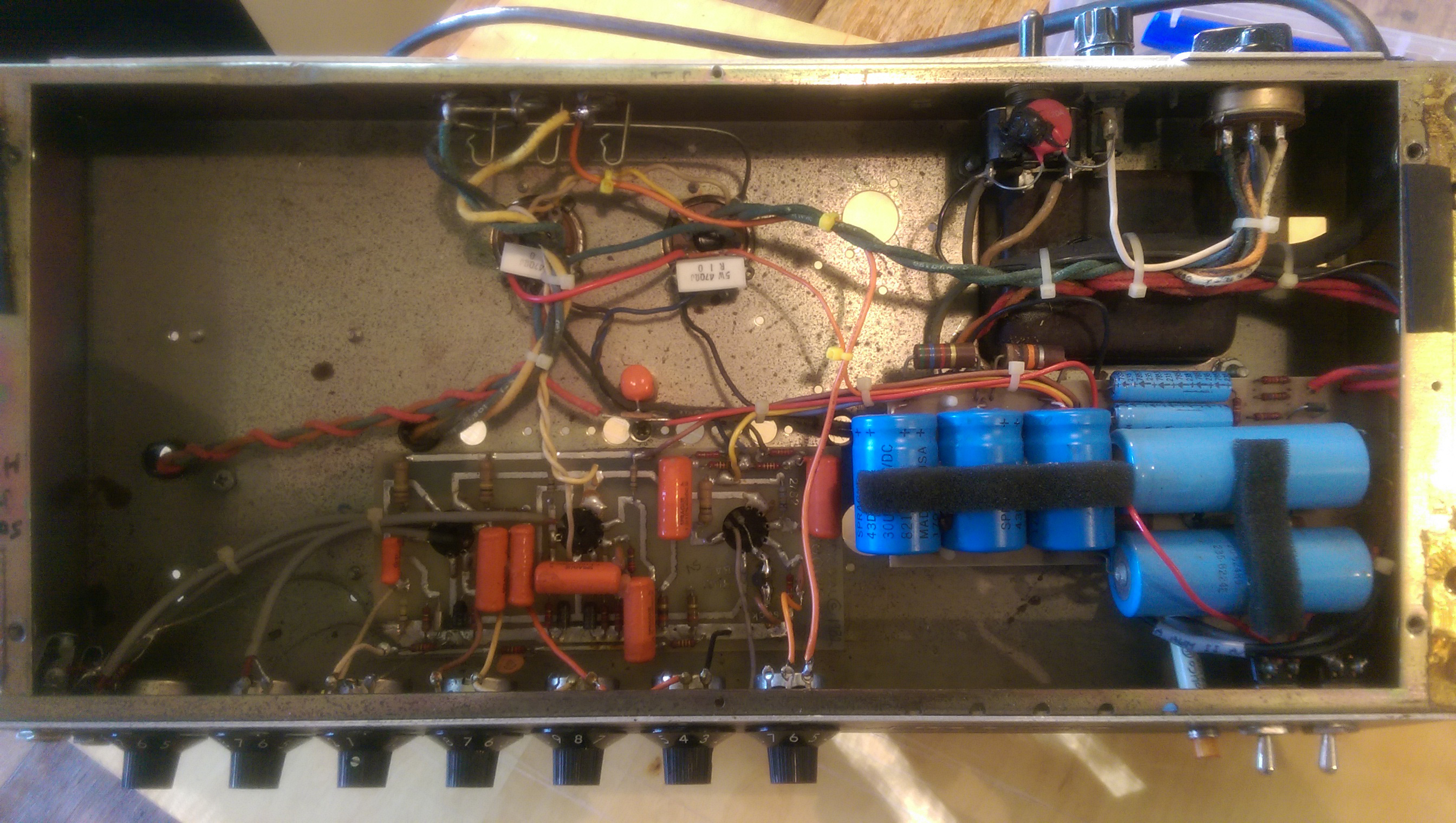 In this pic you can see the whole internals of the amp, and where the other end of the added dark orange wire should be soldered to (see description above). In